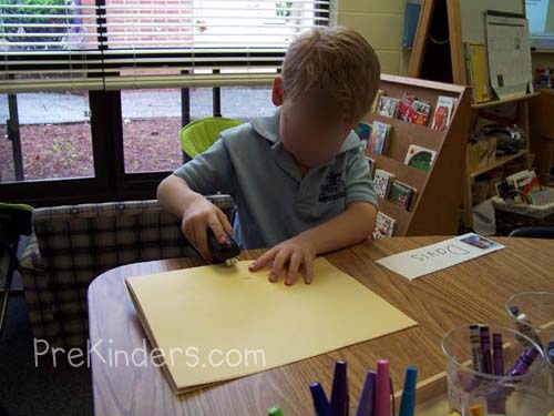a child making a book in preschool