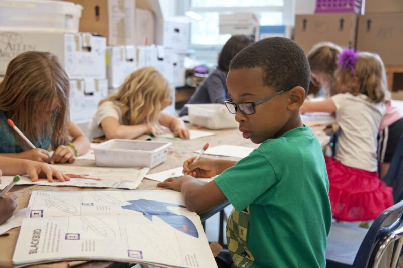 photo-of-a-boy-working-at-a-desk-title-1-school