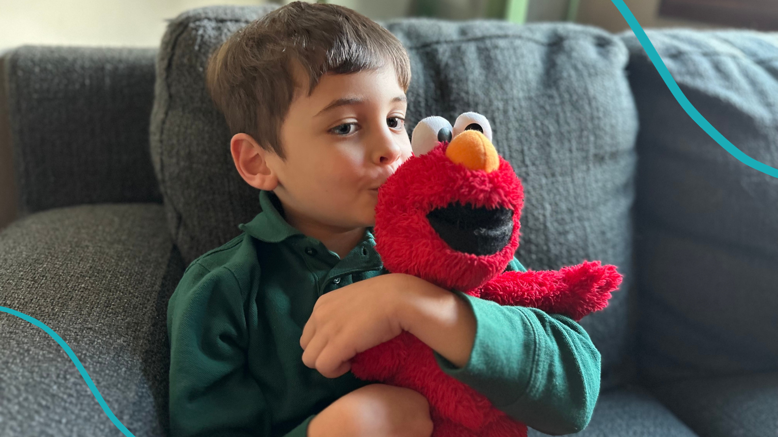 Boy Kissing stuffed Elmo, one of the top 20 Sesame Street characters ranked by kids.