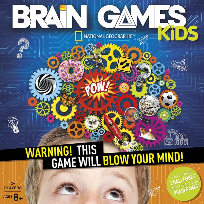 A box has the top of a little boy's face looking up at a bunch of different colored gears. It says Brain Games Kids.