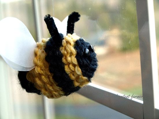 plastic egg covered in yarn to look like a bee 