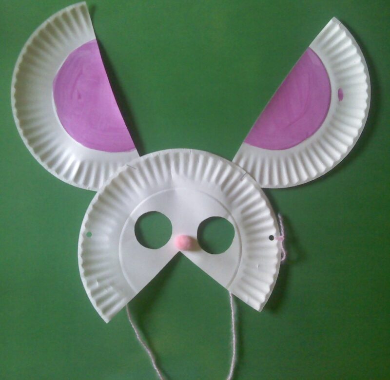 a bunny mask is made from cut up paper plates and holes in it (spring crafts for kids)