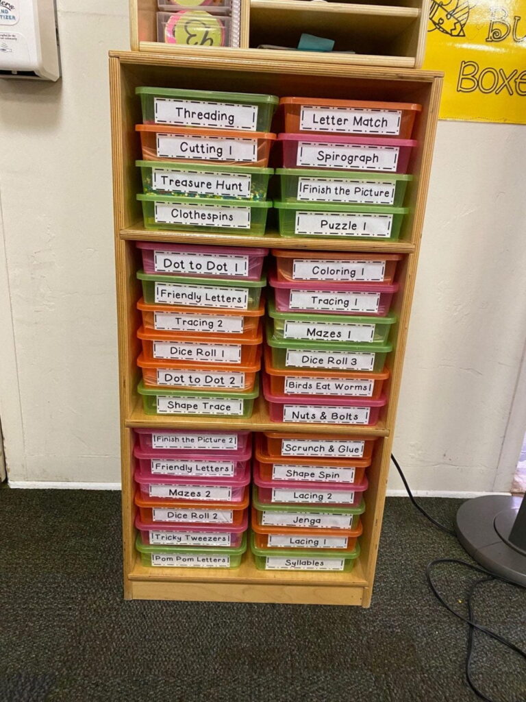 a shelf of busy boxes labeled for student use to help with classroom procedures