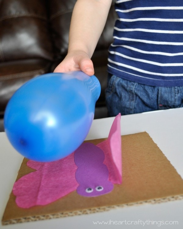 a balloon near a craft butterfly for an electricity experiment