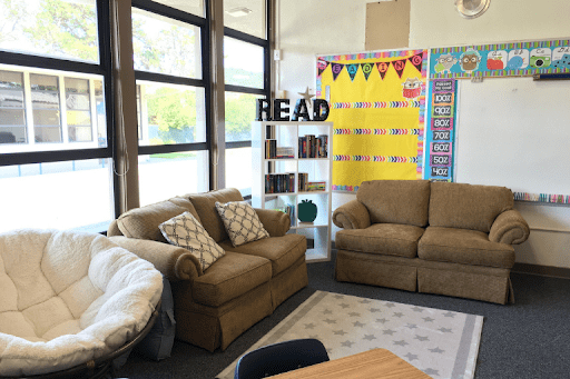Classroom with brown couches and a white papasan chair