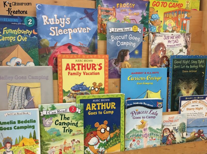 A bookcase that displays books facing outward shows a number of camping themed books for children. 