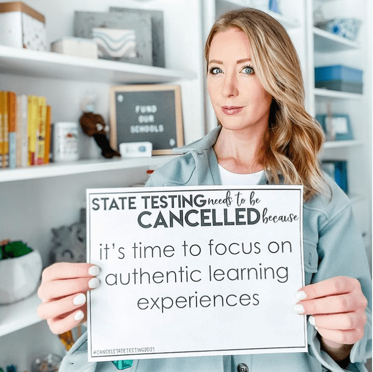 Teacher holding sign to support state testing being cancelled in 2021