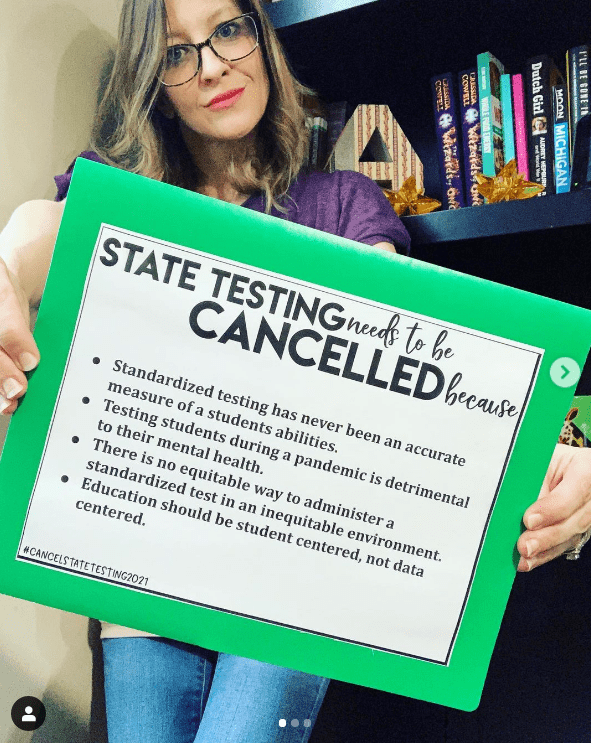 Teacher holding sign to support canceling state testing