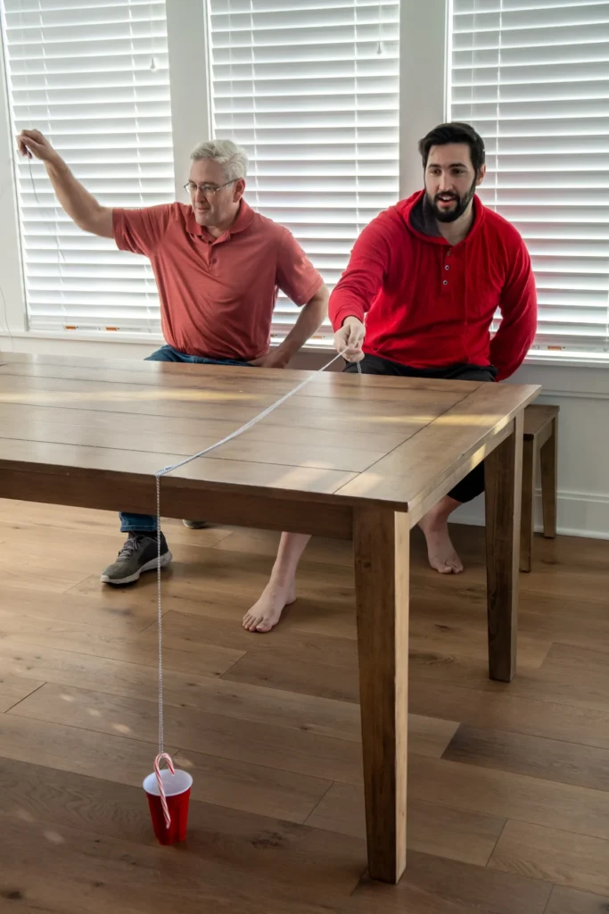 people playing candy cane cup game