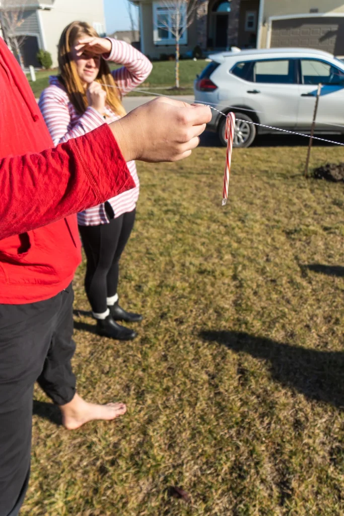 people playing candy cane string game 