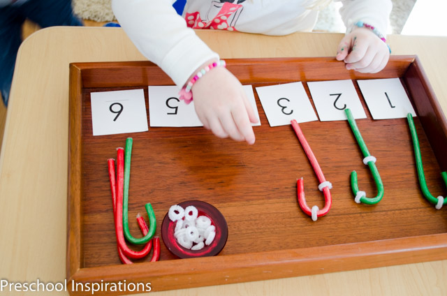 Child adding stripes on candy canes to match a number 