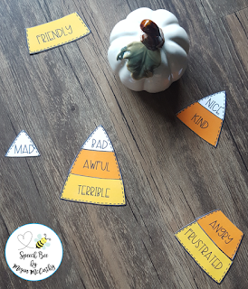 candy corn cut-outs divided up into three colors with a different synonym on each, and a white pumpkin in the background, as an example of activities on synonyms 