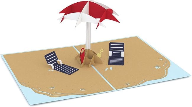 Pop up card of a beach scene with chairs and umbrellas