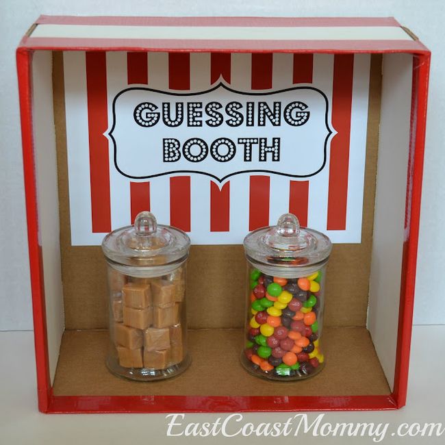 Cardboard box labeled Guessing Booth, with two large jars holding candy 