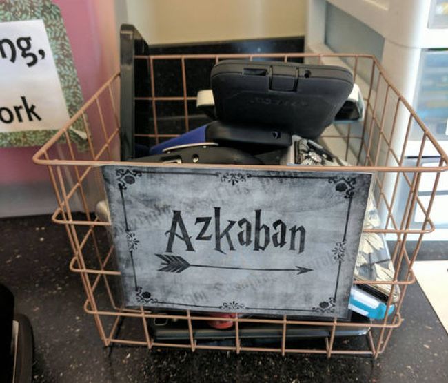 Wire bin holding cell phones labeled Azkaban
