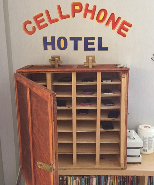 Cell Phone Hotel built of wood with slots for cell phones and a locking door (Cell Phones in Class)