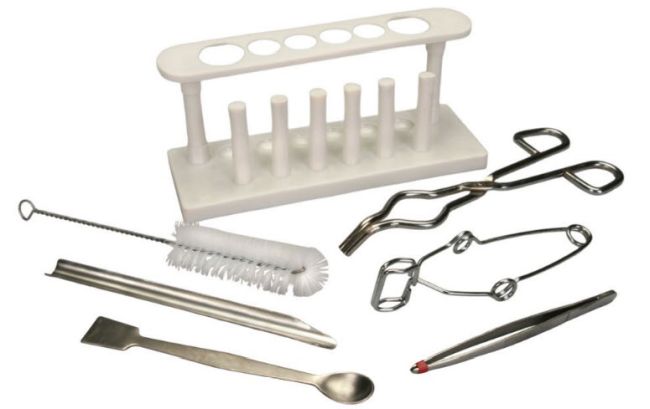 A set of chemistry lab equipment tools, including test tube rack, crucible tongs, scoop, tweezers, and more