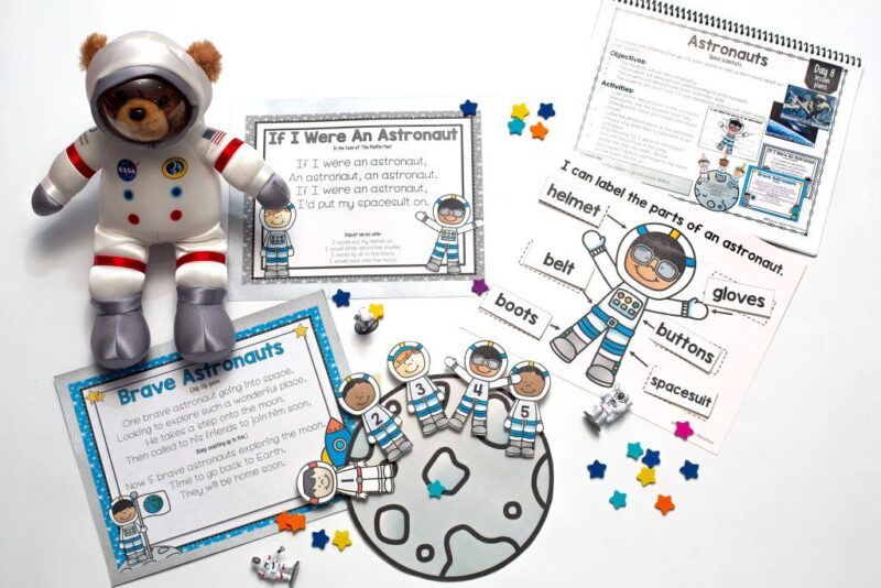 Space-themed classroom supplies are shown including small astronauts that are numbered 1 through 5 and a teddy bear wearing an astronaut suit.