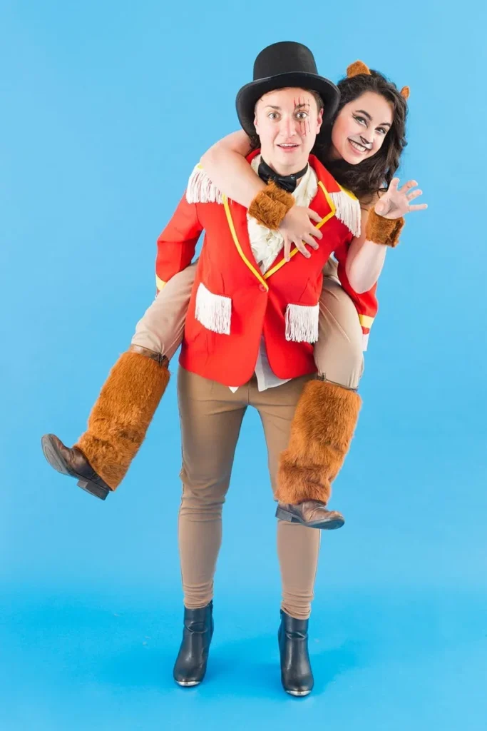 Teacher Halloween costumes include a man dressed as a ringmaster with a woman dressed as a lion on his back.