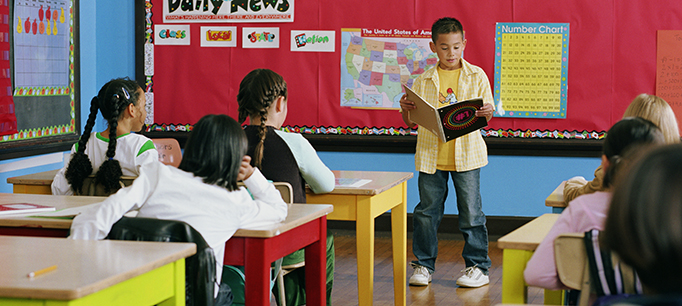 Student giving a presentation in front of the class as an example of fun last day of school activities