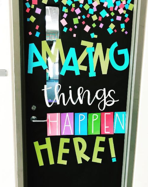 Classroom door saying Amazing Things Happen Here in colorful letters and different fonts