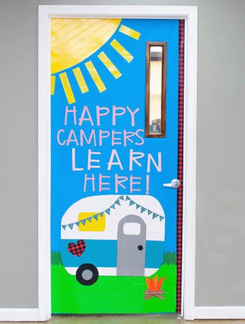 Happy Campers Learn Here classroom door with a camper van and sunshine