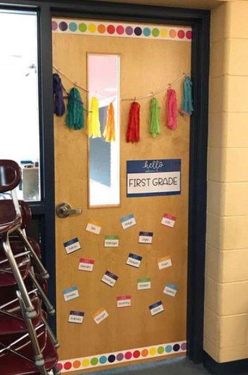 Classroom door decorated with colorful border and tassels, and Hello, My Name Is... tags for each student