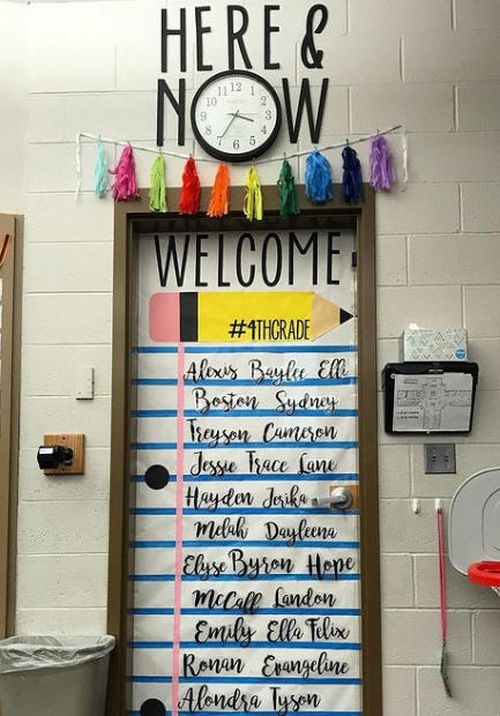 Classroom door decorated to look like a piece of notebook paper with students names handwritten on the page.