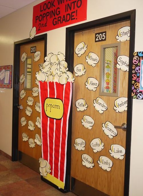 Classroom doors decorated with pieces of popcorn with student names. In between is a large paper bucket of popcorn.