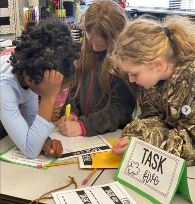 Students solving a task in a classroom escape room