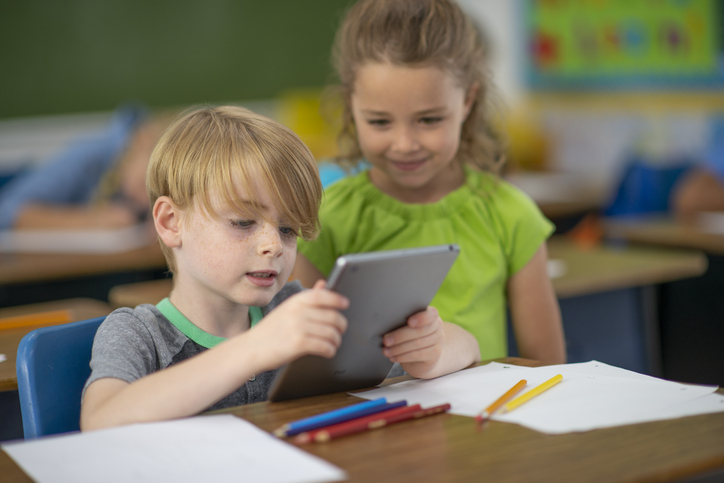 Two students look at an reader together