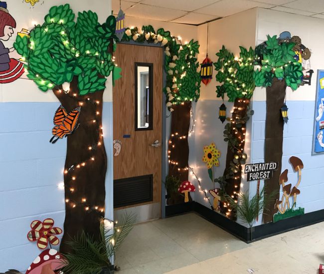 Classroom door with large paper trees and strings of lights