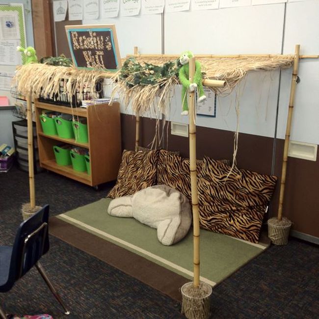A tiki-hut reading nook in a classroom with other jungle decorations