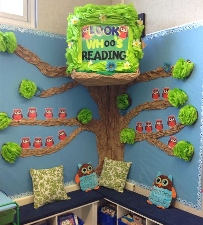 DIY tree with owls on the branches, part of a classroom reading nook with benches
