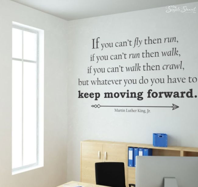 Vinyl lettering on a wall in a classroom reading "If you can't fly, then run, if you can't run then walk, if you can't walk them crawl, but whatever you do you have to keep moving forward." - Martin Luther King, Jr.