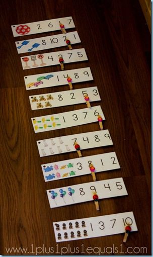 number strips with colorful images and numerals with clothespins attached