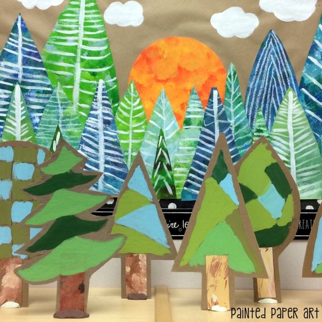 A collaborative art project of 3-D paper forest of painted pine trees 