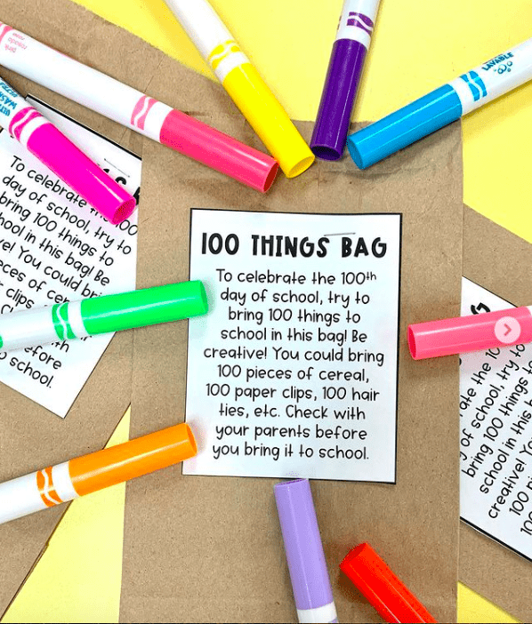 A printed assignment for a 100 Things Bag lies on a table surrounded by colored markers