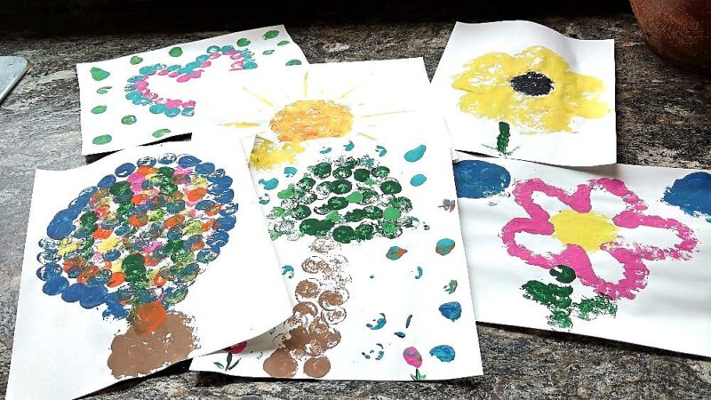 Several paintings of trees and flowers, etc. are shown. They are stamped with a cork dipped in paint. 