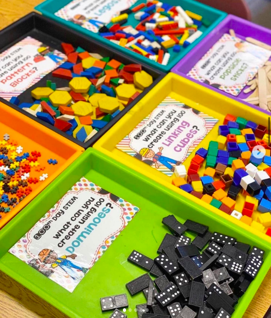 Colorful bins of math manipulatives to use for 100th day of school counting stations.