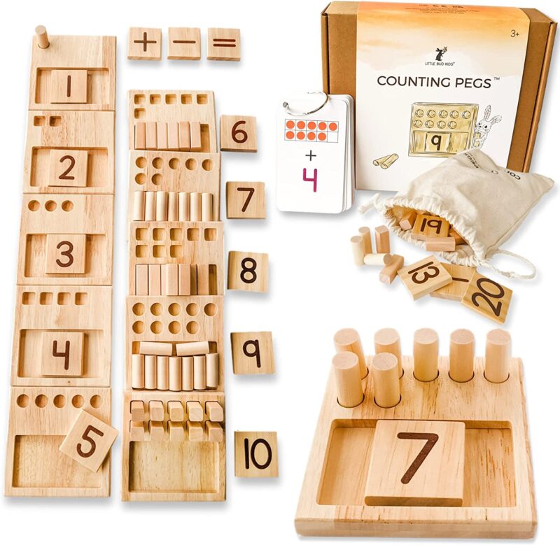 Several wooden boxes have different numbers of spots in them for pegs and corresponding wooden numbers. (math board games)