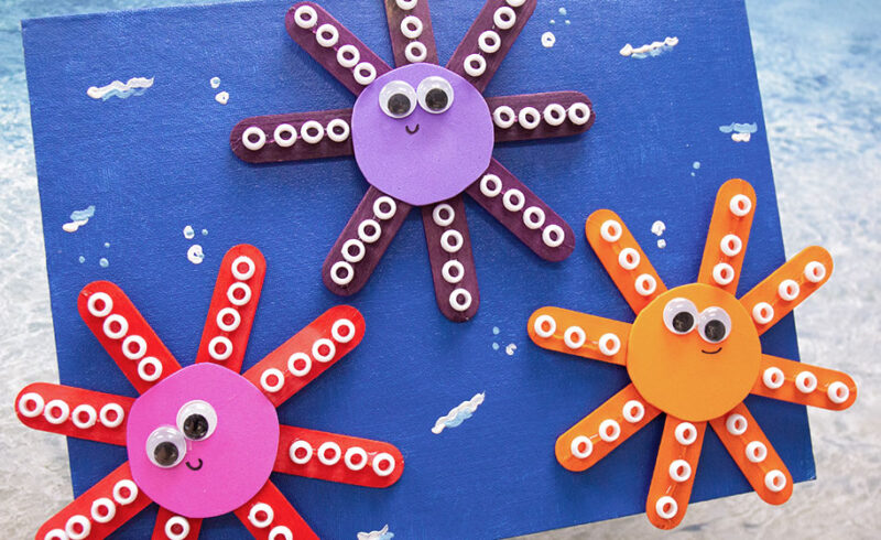 Three DIY octopi made from craft sticks, beads, construction paper and googly eyes