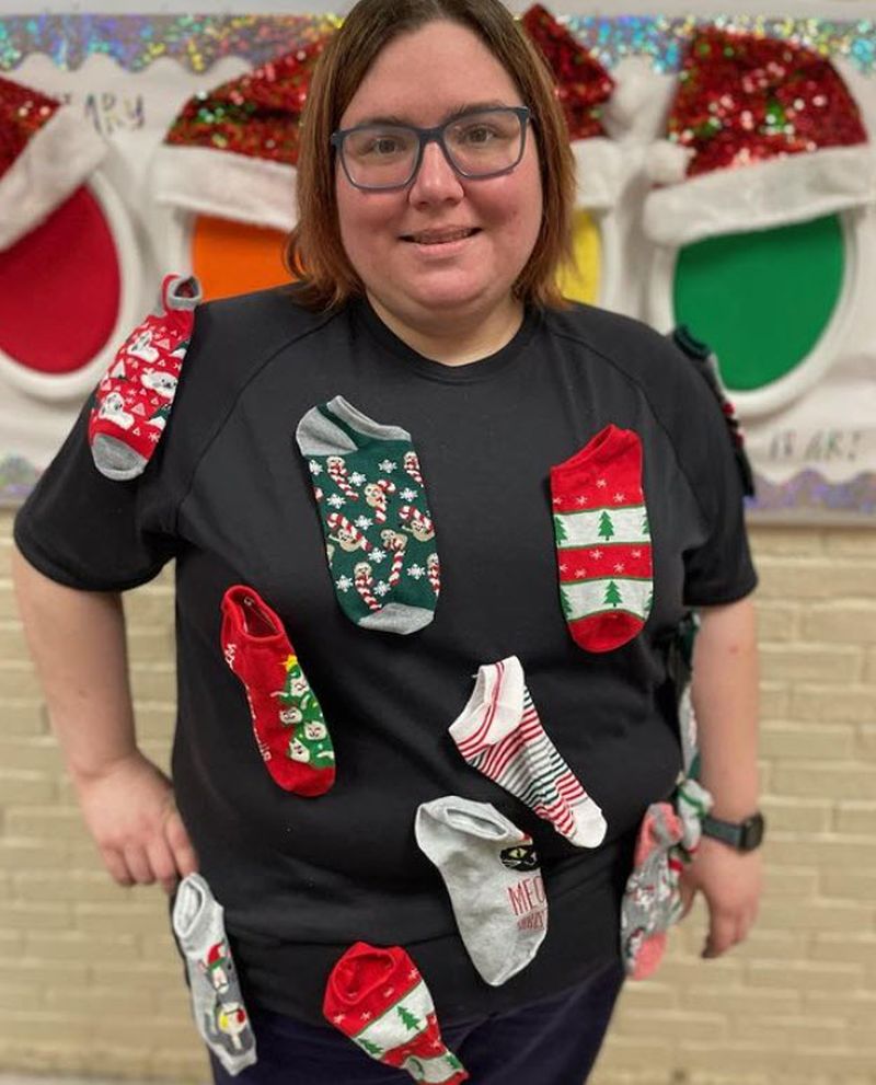 Teacher wearing a shirt covered in silly socks for Crazy Sock Day