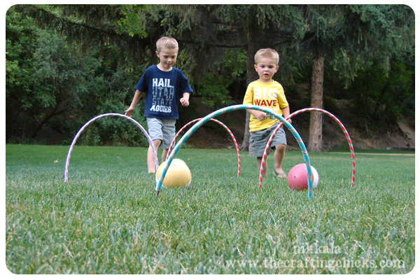 Kids playing croquet with hula hoops