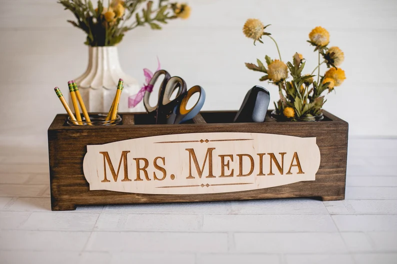 A wooden desk organizer says Mrs. Medina