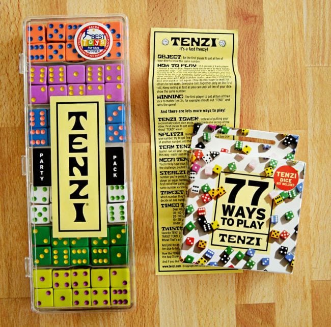 Tenzi box holding 7 colorful sets of 10 dice each, Tenzi scorecard, and deck of 77 Ways to Play Tenzi cards (Dice Games)