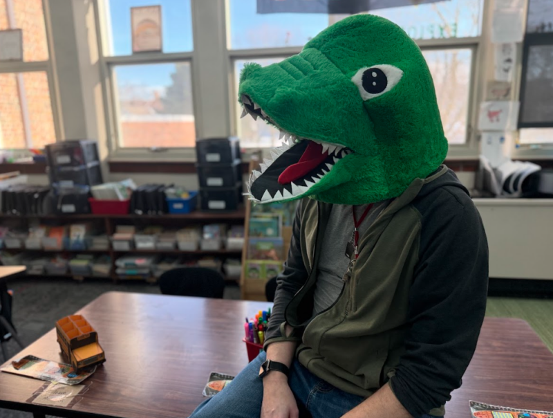 dinosaur teacher sitting
