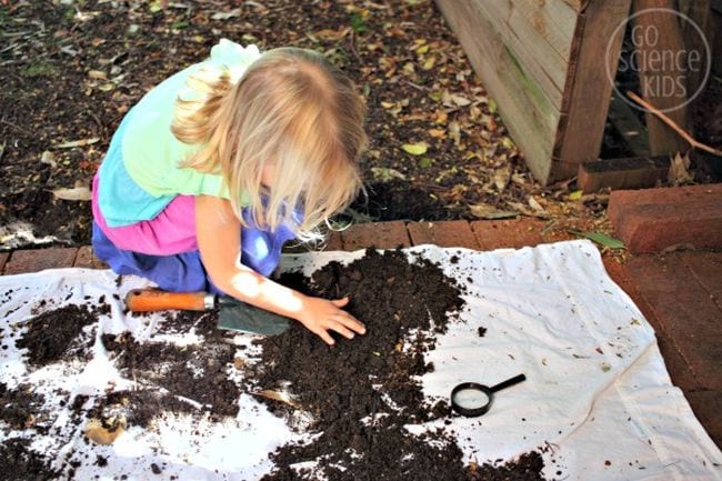 Girl digging through dirt 