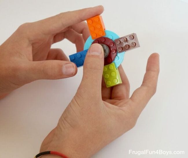 Student playing with a LEGO fidget spinner