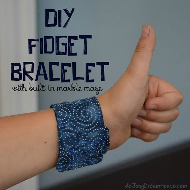 Child wearing a fabric DIY Fidget Bracelet with a hidden marble maze